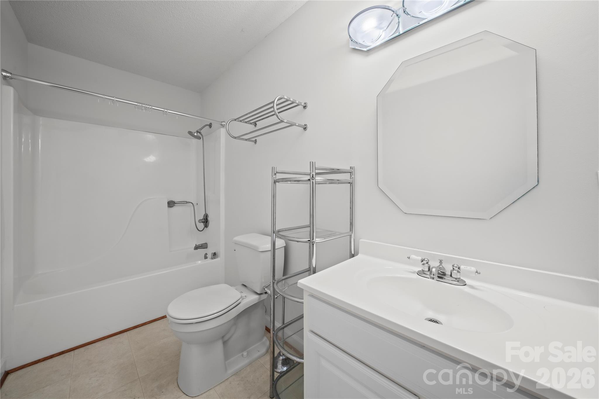 10670 Troutman Road Midland, NC 28107 - Photo 28 of 37 a bathroom with a sink a toilet and shower