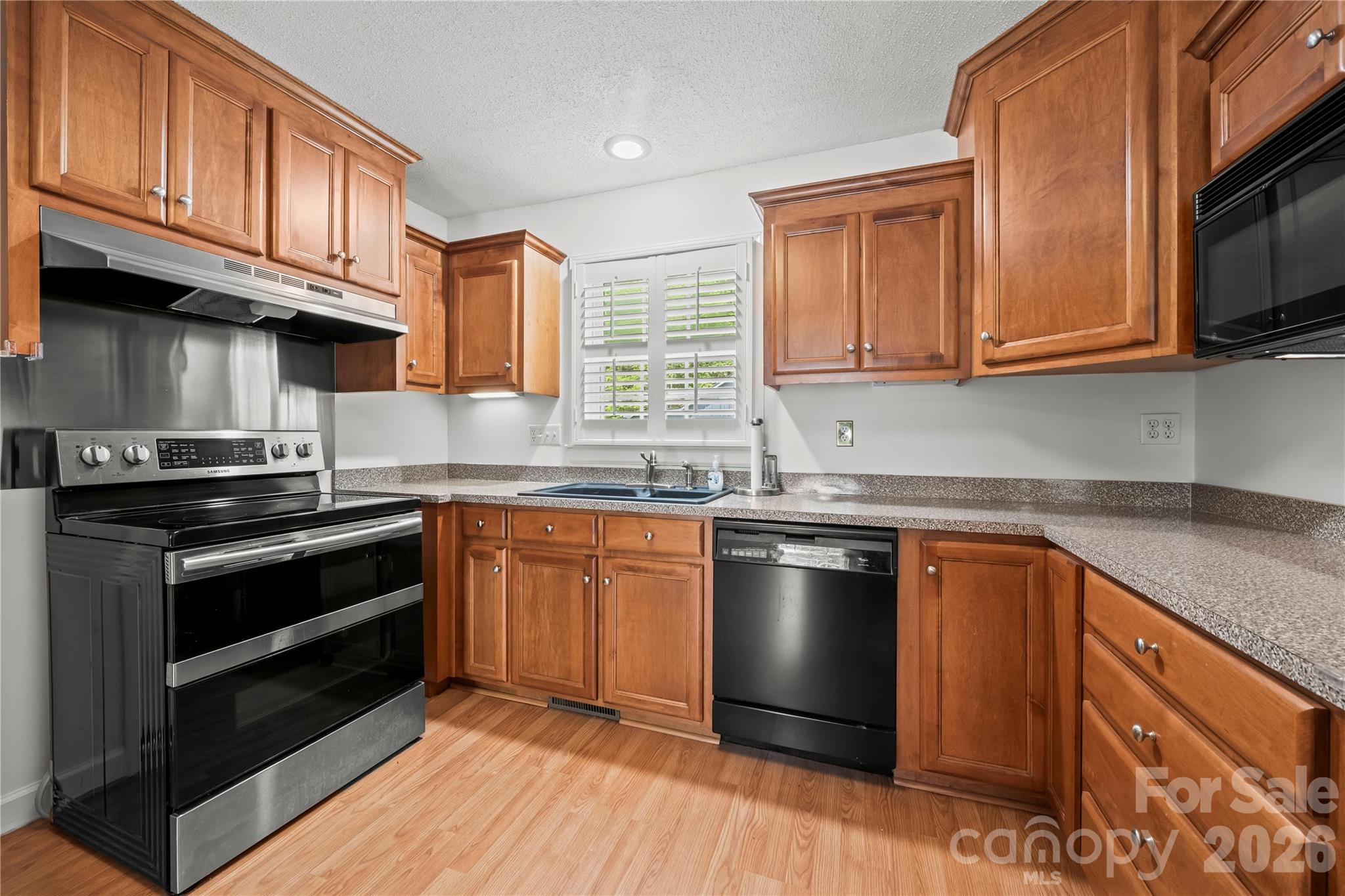 10670 Troutman Road Midland, NC 28107 - Photo 3 of 37 a kitchen with stainless steel appliances granite countertop a stove a sink and a microwave