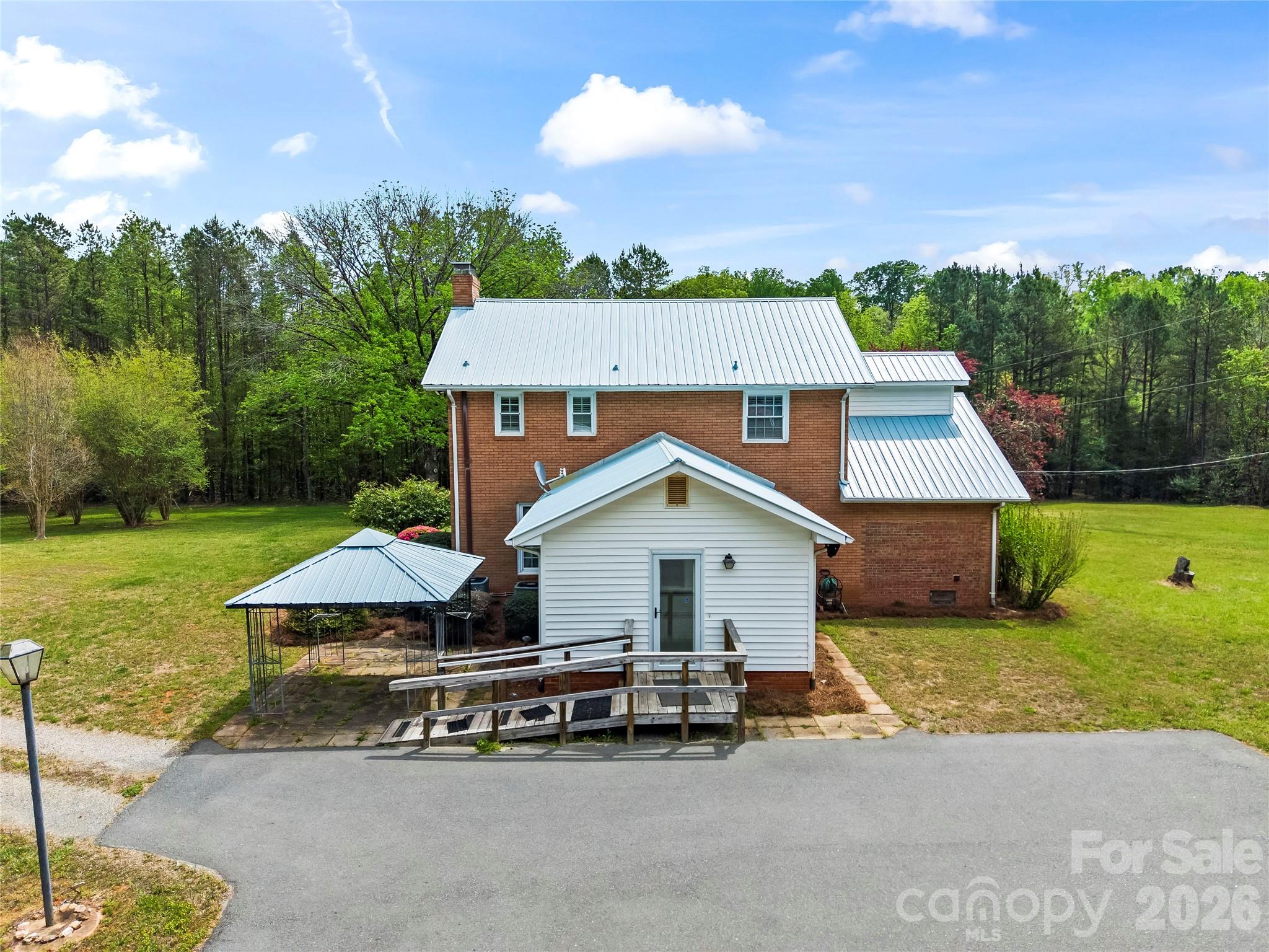 10670 Troutman Road Midland, NC 28107 - Photo 34 of 37 a view of a house with a yard porch and sitting area