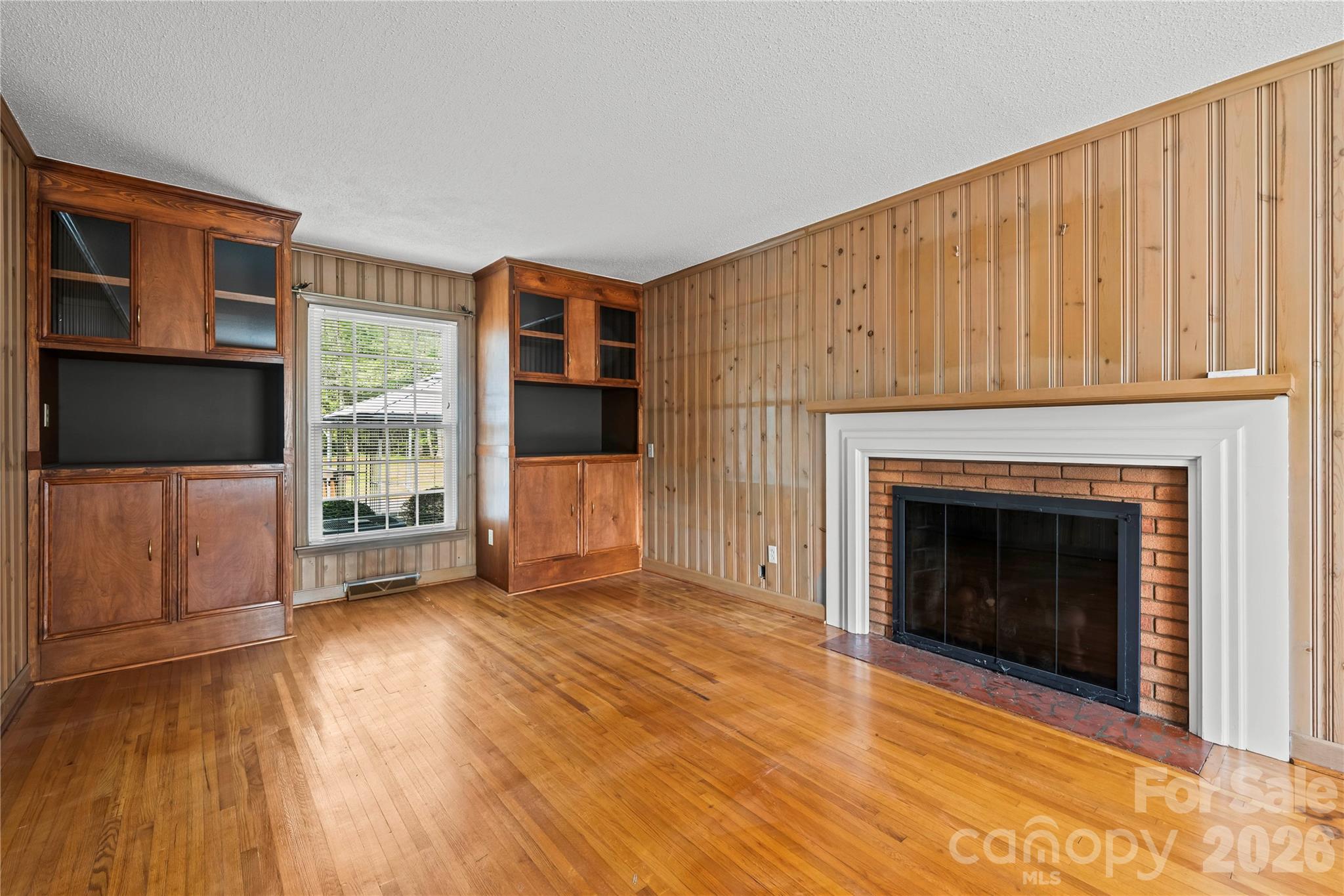 10670 Troutman Road Midland, NC 28107 - Photo 10 of 37 a view of a livingroom with wooden floor and a fireplace