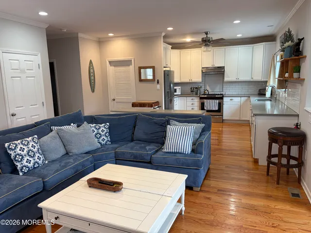 a living room with furniture and kitchen view