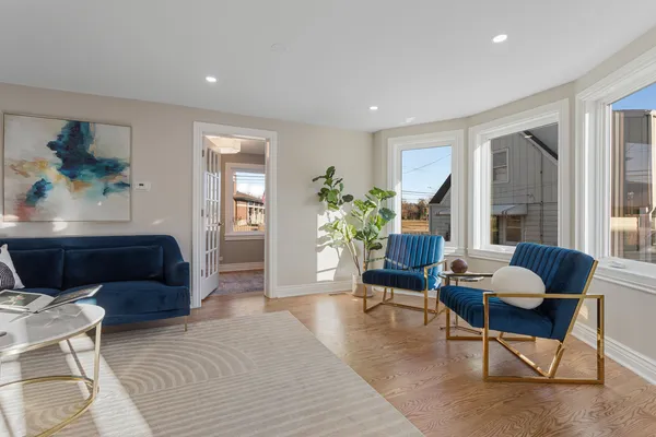 a living room with furniture and a potted plant