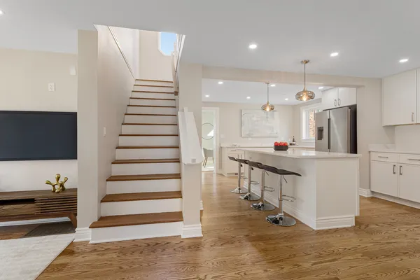 a kitchen with stainless steel appliances kitchen island sink refrigerator and stove