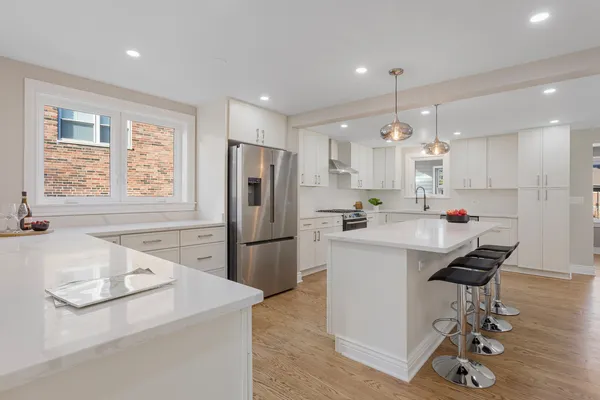 a kitchen with refrigerator and windows