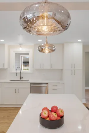 a kitchen with a chandelier a sink and chandelier
