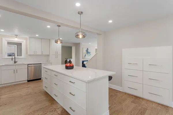 a kitchen that has a sink a window and stainless steel appliances