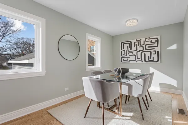 a view of a dining room with furniture wooden floor and a window
