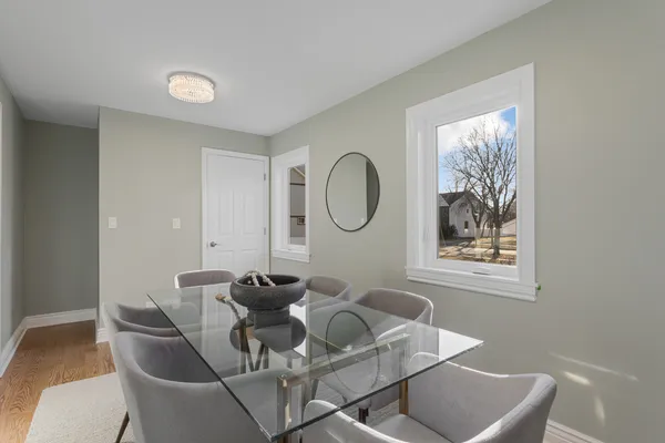 a dining room with furniture and a mirror