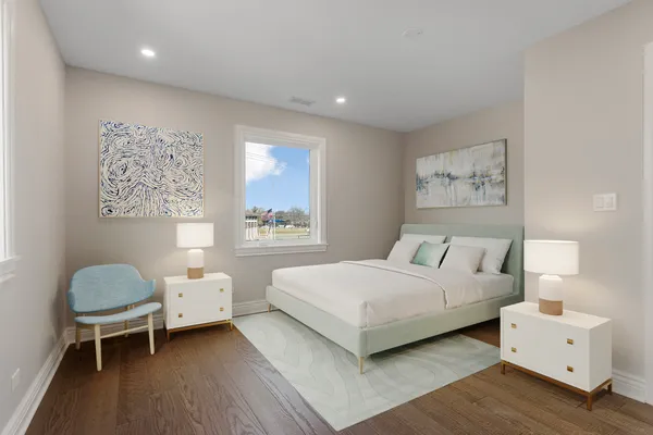 a bedroom with a bed and a lamp on dresser