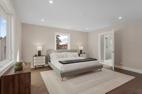 a spacious bedroom with a bed and a couch