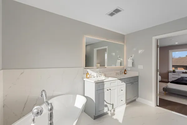 a spacious bathroom with a granite countertop sink and a mirror