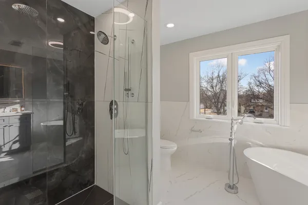 a bathroom with a shower a toilet and sink