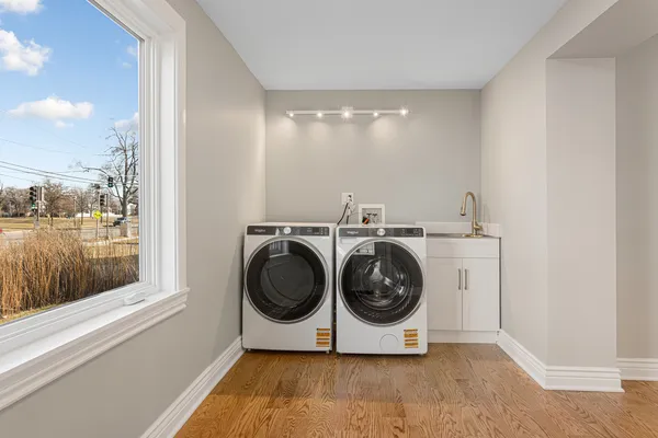 a utility room with sink dryer and washer