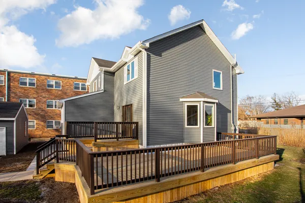 a view of a house with wooden fence