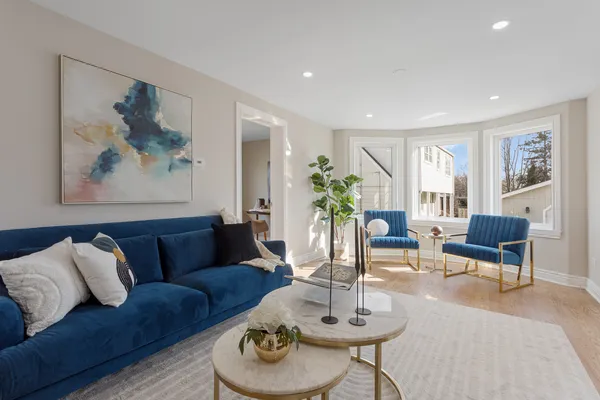 a living room with furniture potted plant and a window