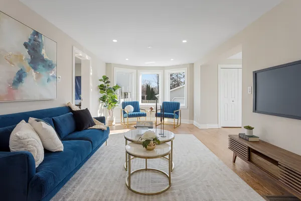 a living room with furniture a rug and a flat screen tv