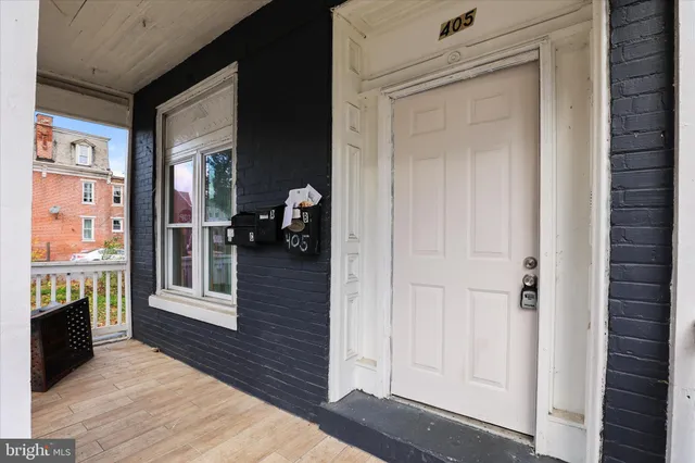 a view of a entryway door of the house and living room