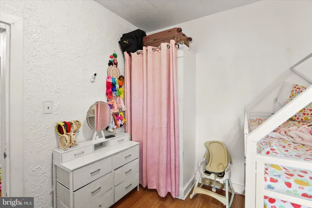 a view of a bedroom with baby bed and a window