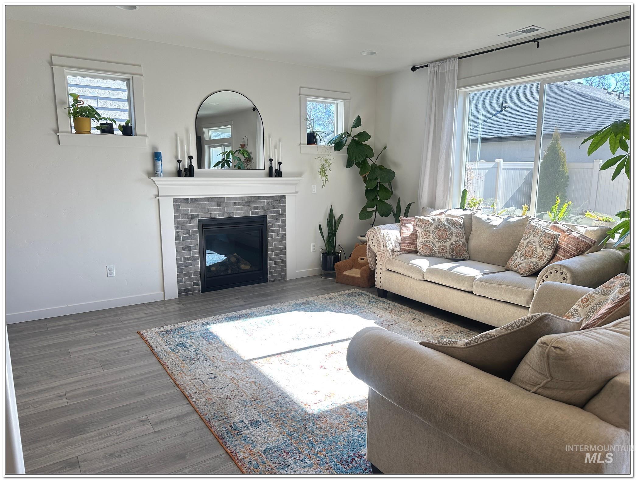 9687 West Arnold Road Boise, ID 83714 - Photo 9 of 49 Living area featuring wood finished floors, healthy amount of natural light, and a fireplace