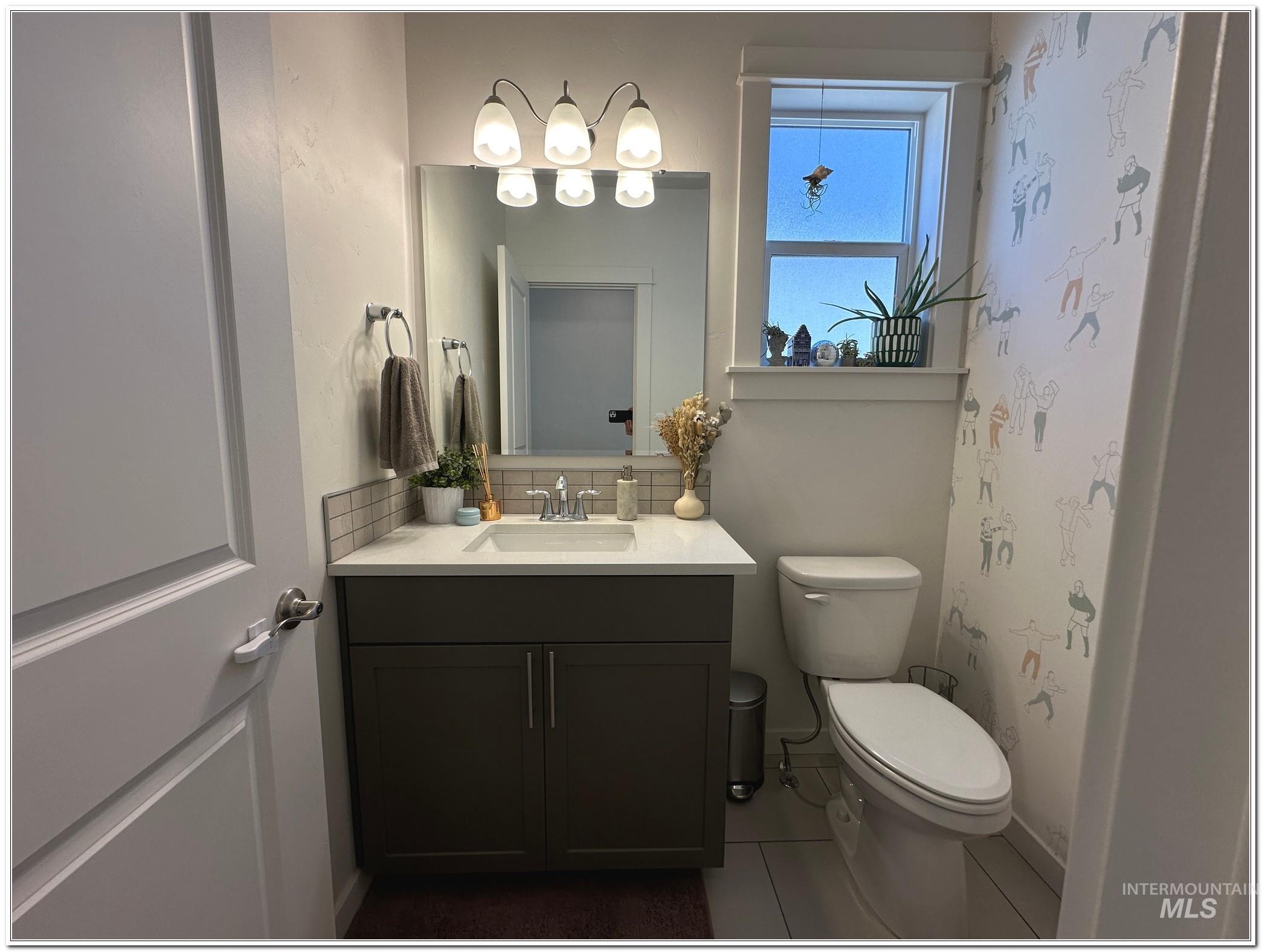 9687 West Arnold Road Boise, ID 83714 - Photo 15 of 49 Bathroom featuring decorative backsplash, vanity, and dark tile patterned floors