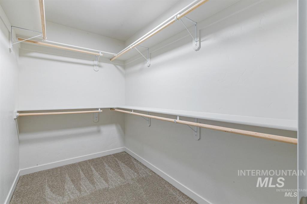 9687 West Arnold Road Boise, ID 83714 - Photo 20 of 49 Walk in closet featuring light colored carpet. Photo from prior to move in.