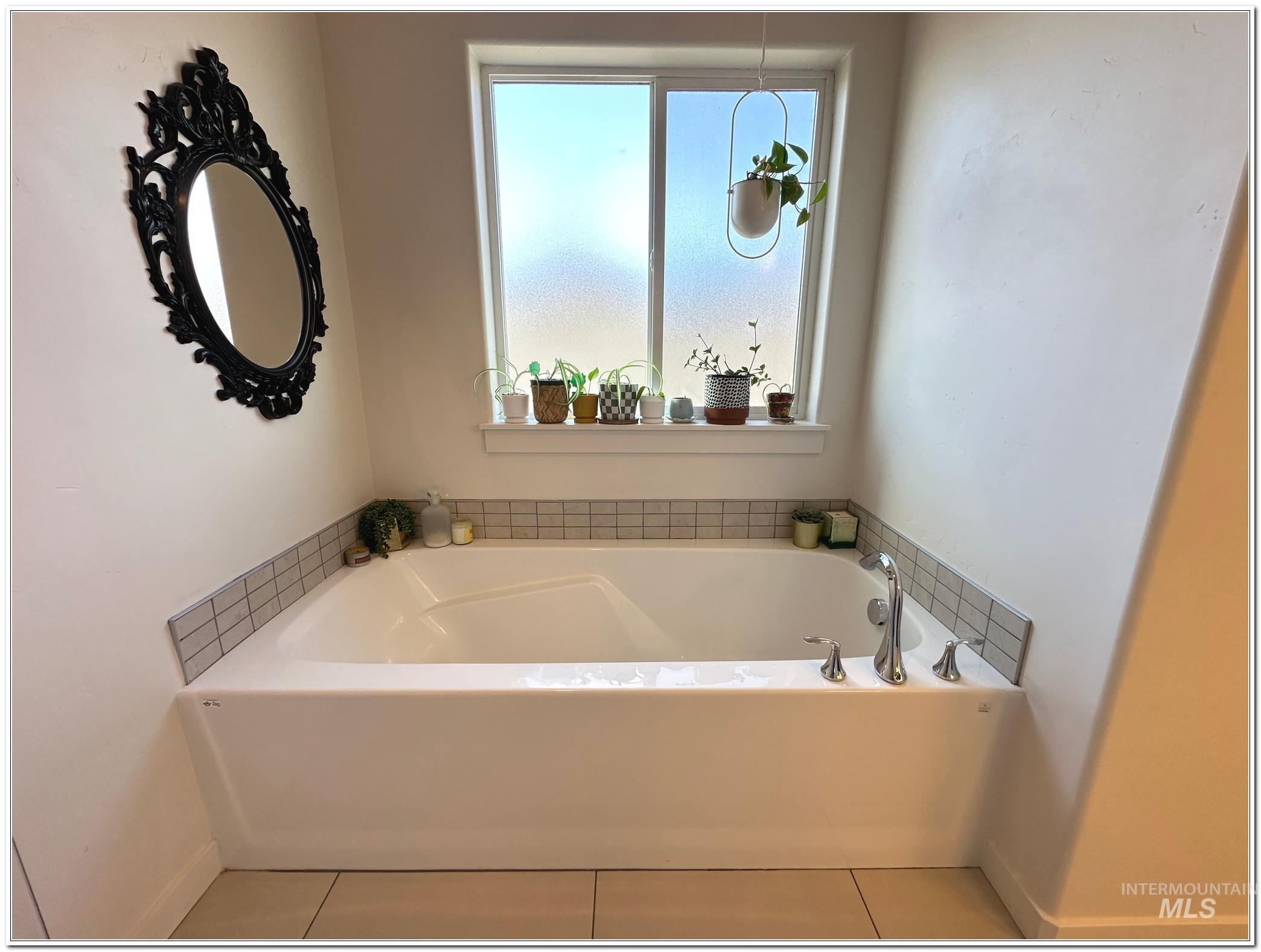 9687 West Arnold Road Boise, ID 83714 - Photo 22 of 49 Full bathroom featuring a bath and light tile patterned floors