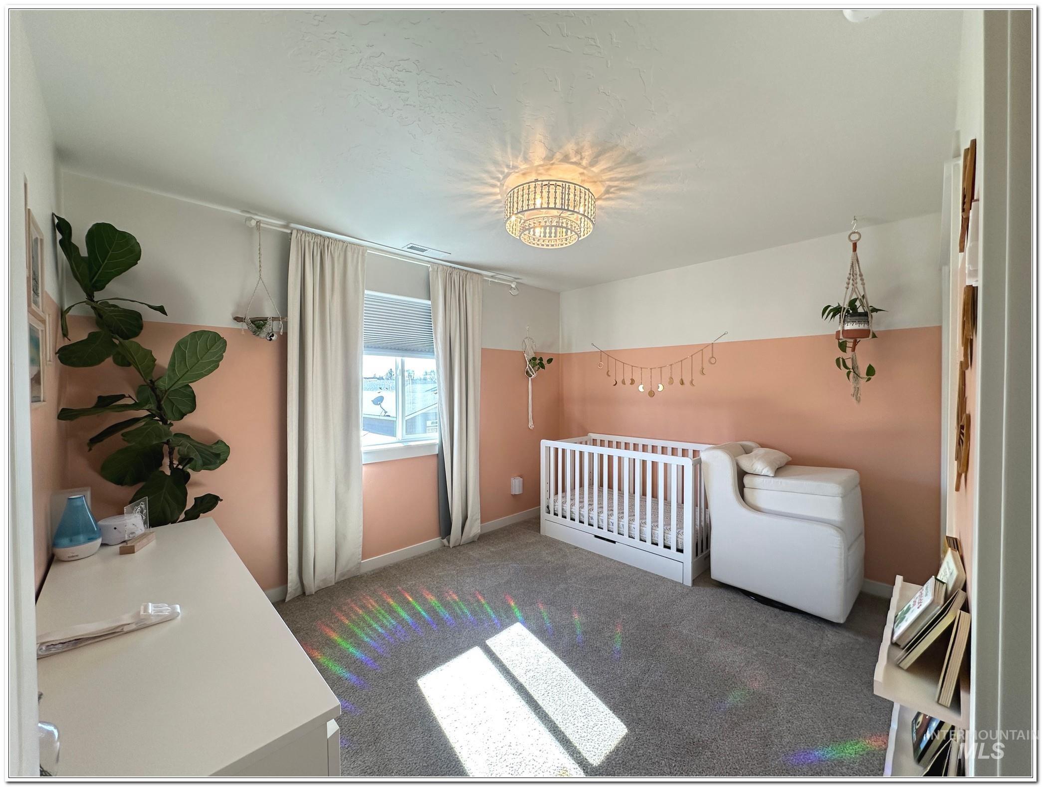 9687 West Arnold Road Boise, ID 83714 - Photo 26 of 49 Bedroom with a nursery area and dark carpet