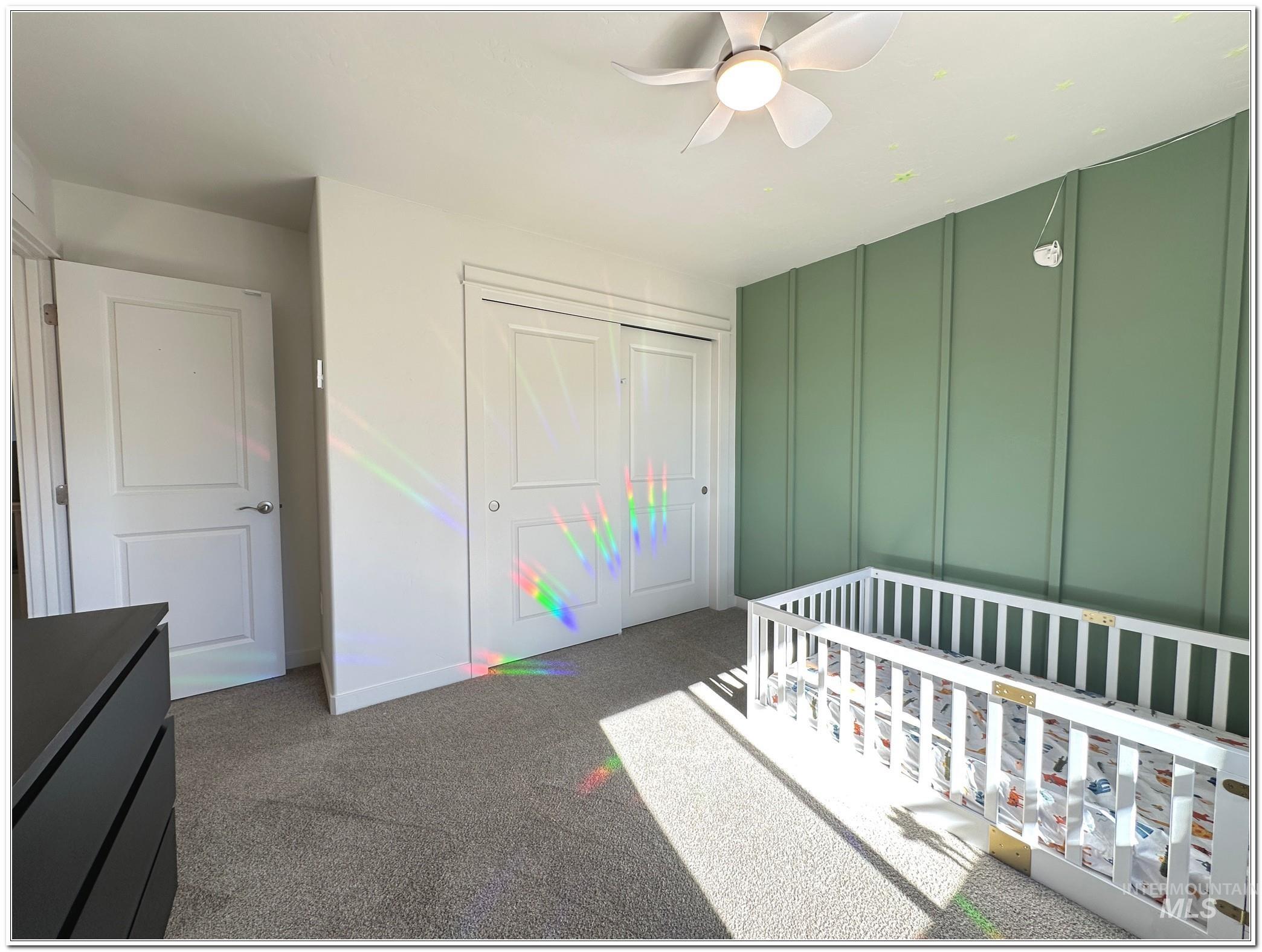9687 West Arnold Road Boise, ID 83714 - Photo 29 of 49 Carpeted bedroom with a closet, a nursery area, and ceiling fan