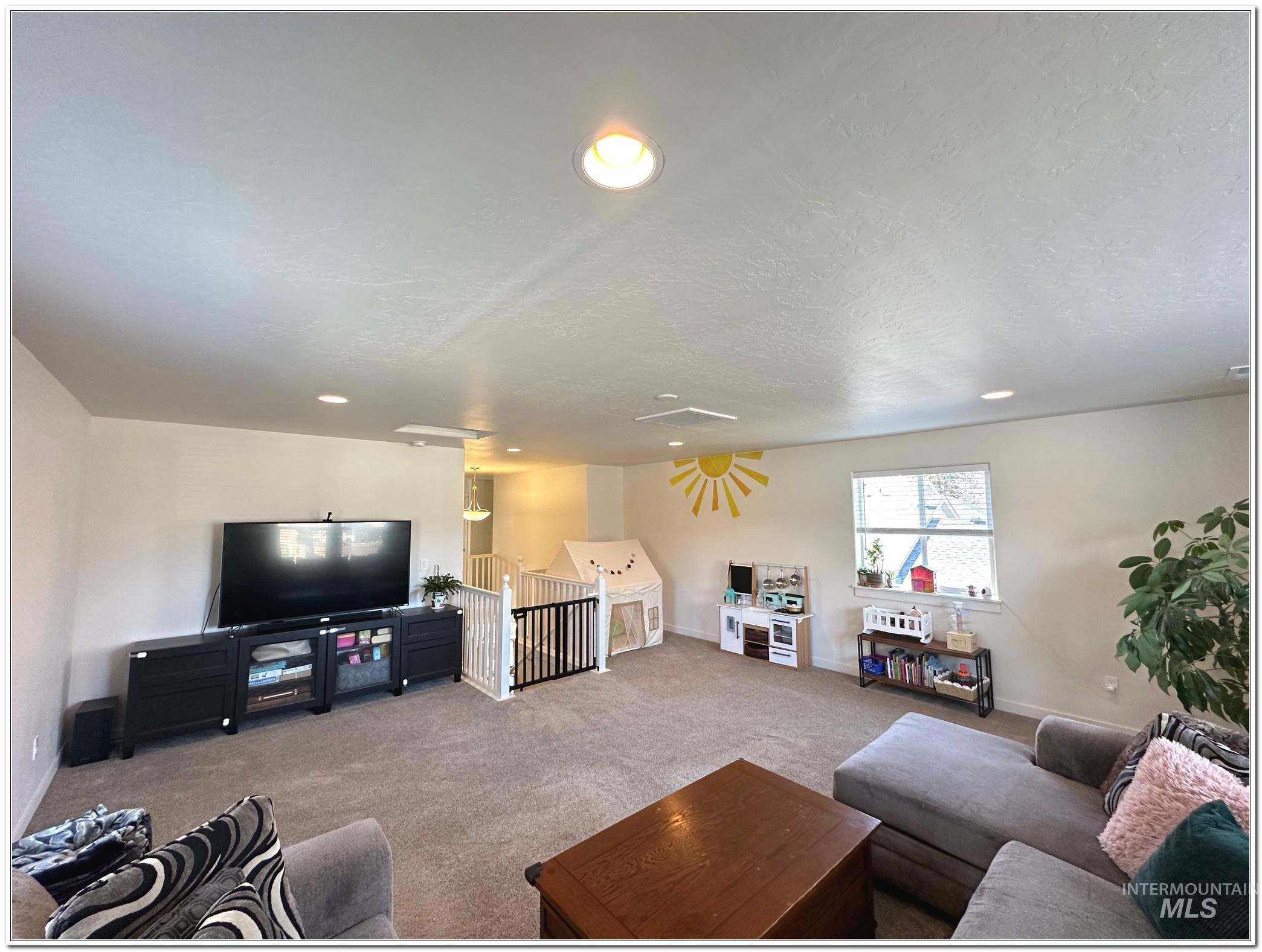 9687 West Arnold Road Boise, ID 83714 - Photo 37 of 49 Carpeted living room with a textured ceiling and recessed lighting
