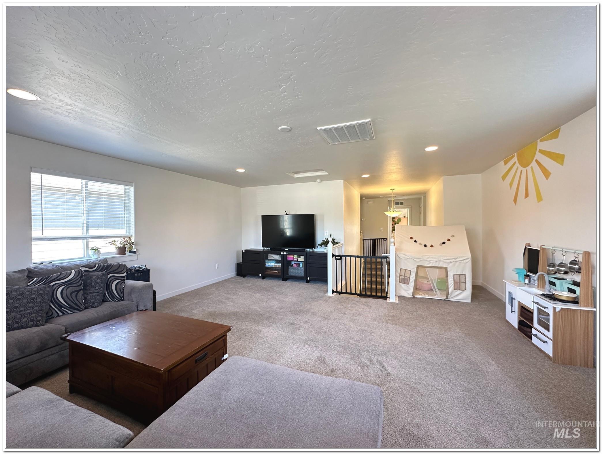 9687 West Arnold Road Boise, ID 83714 - Photo 38 of 49 Living room with carpet, a textured ceiling, and recessed lighting
