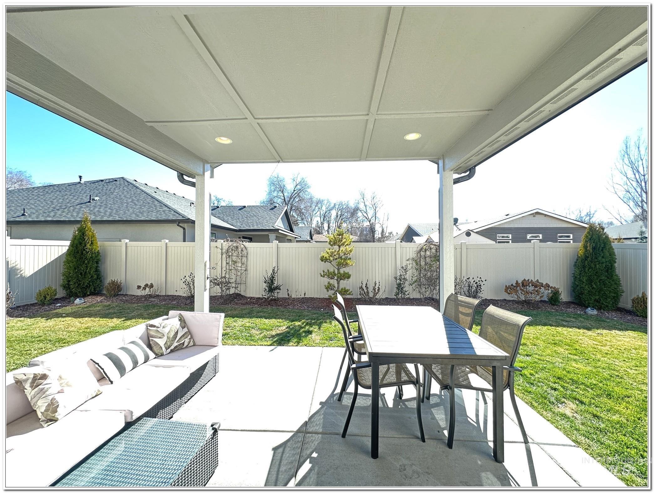 9687 West Arnold Road Boise, ID 83714 - Photo 39 of 49 Fenced backyard with a patio and an outdoor living / dining area