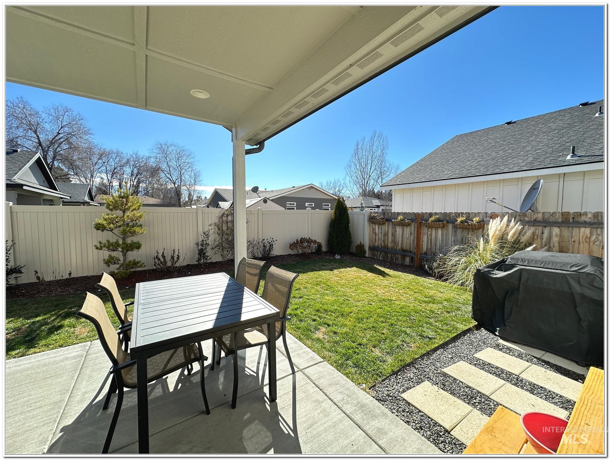 9687 West Arnold Road Boise, ID 83714 - Photo 40 of 49 Fenced backyard featuring a patio, grilling area, and outdoor dining space