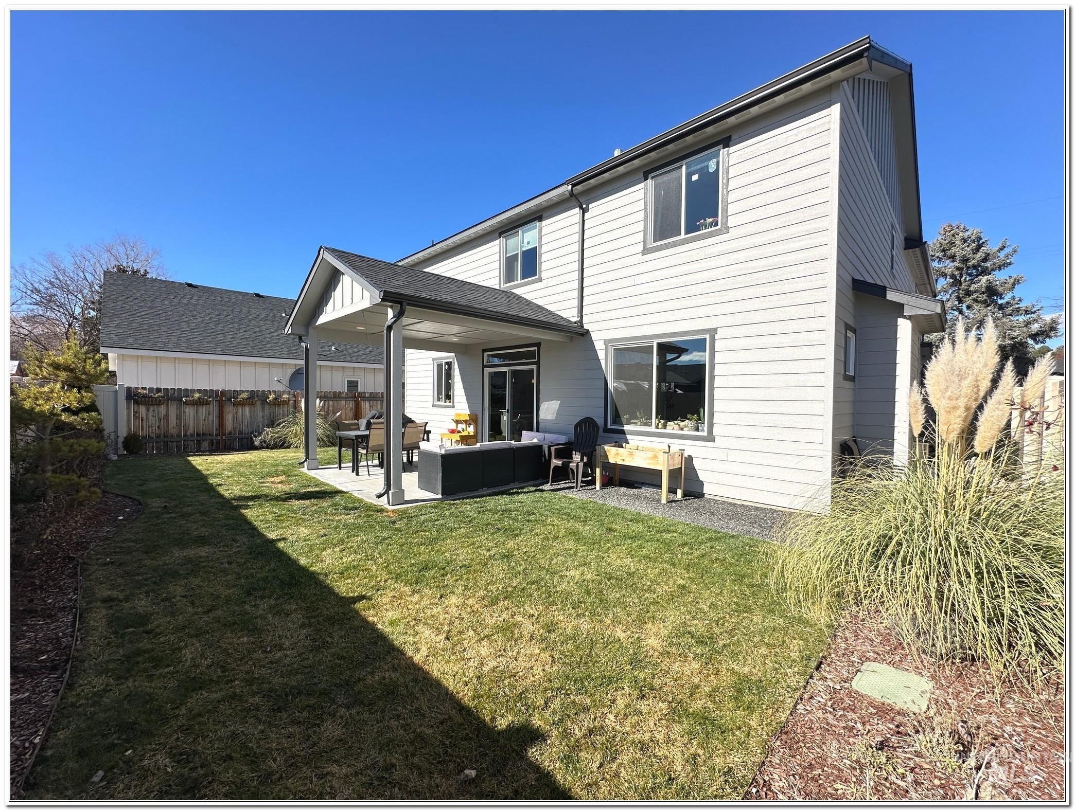 9687 West Arnold Road Boise, ID 83714 - Photo 45 of 49 Back of house featuring outdoor lounge area, a patio area, and a fenced backyard
