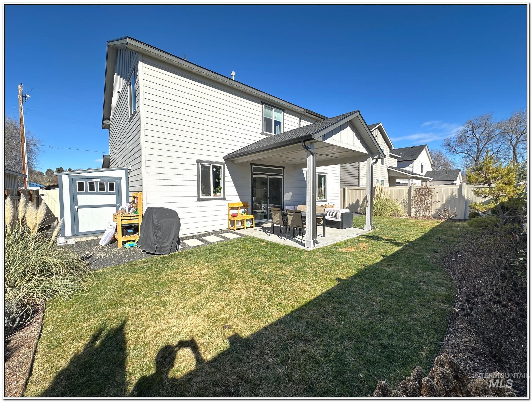 9687 West Arnold Road Boise, ID 83714 - Photo 46 of 49 Rear view of property with a patio area and a storage shed