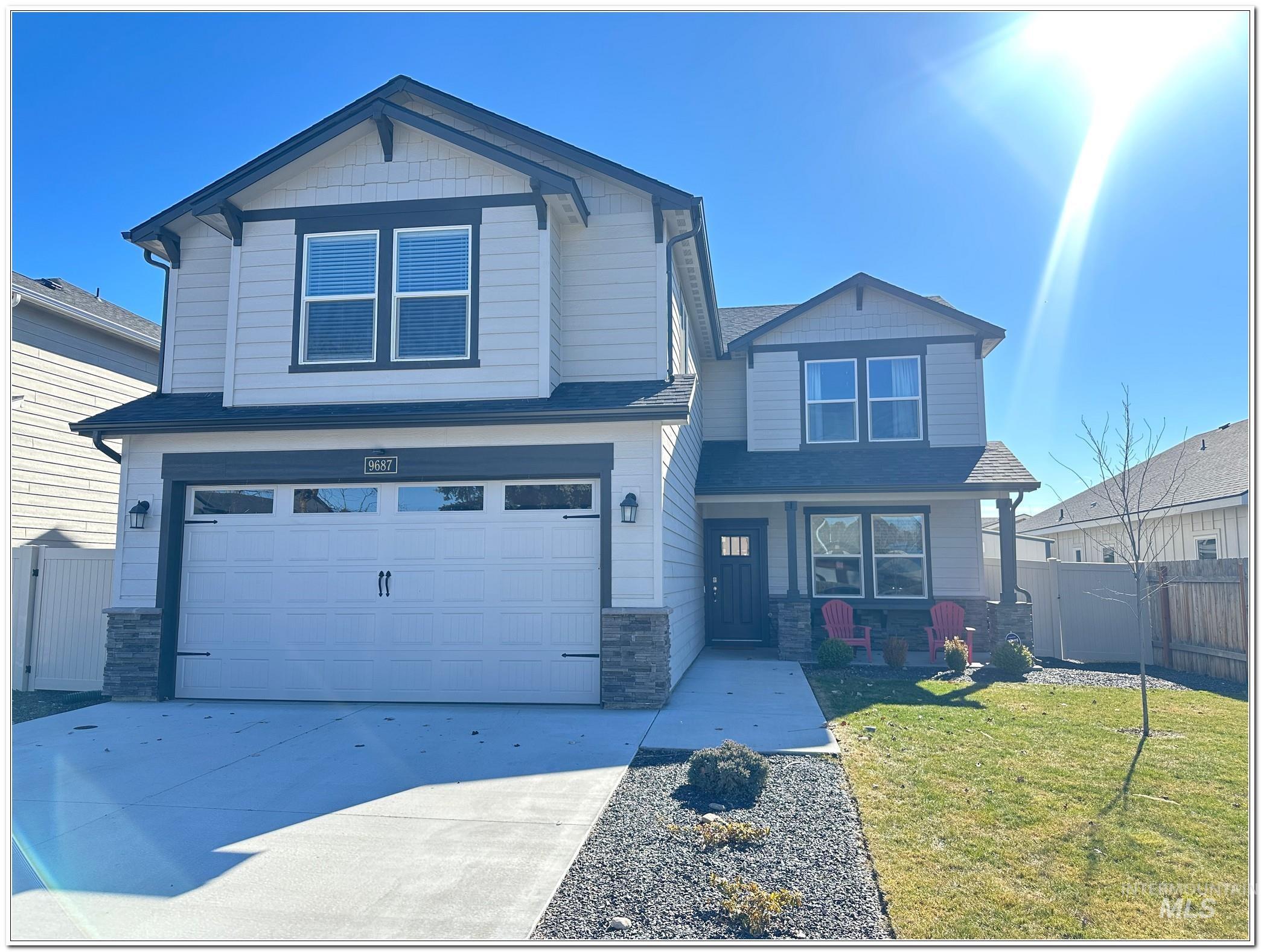 9687 West Arnold Road Boise, ID 83714 - Photo 47 of 49 Craftsman inspired home featuring stone siding, a gate, a garage, driveway, and roof with shingles