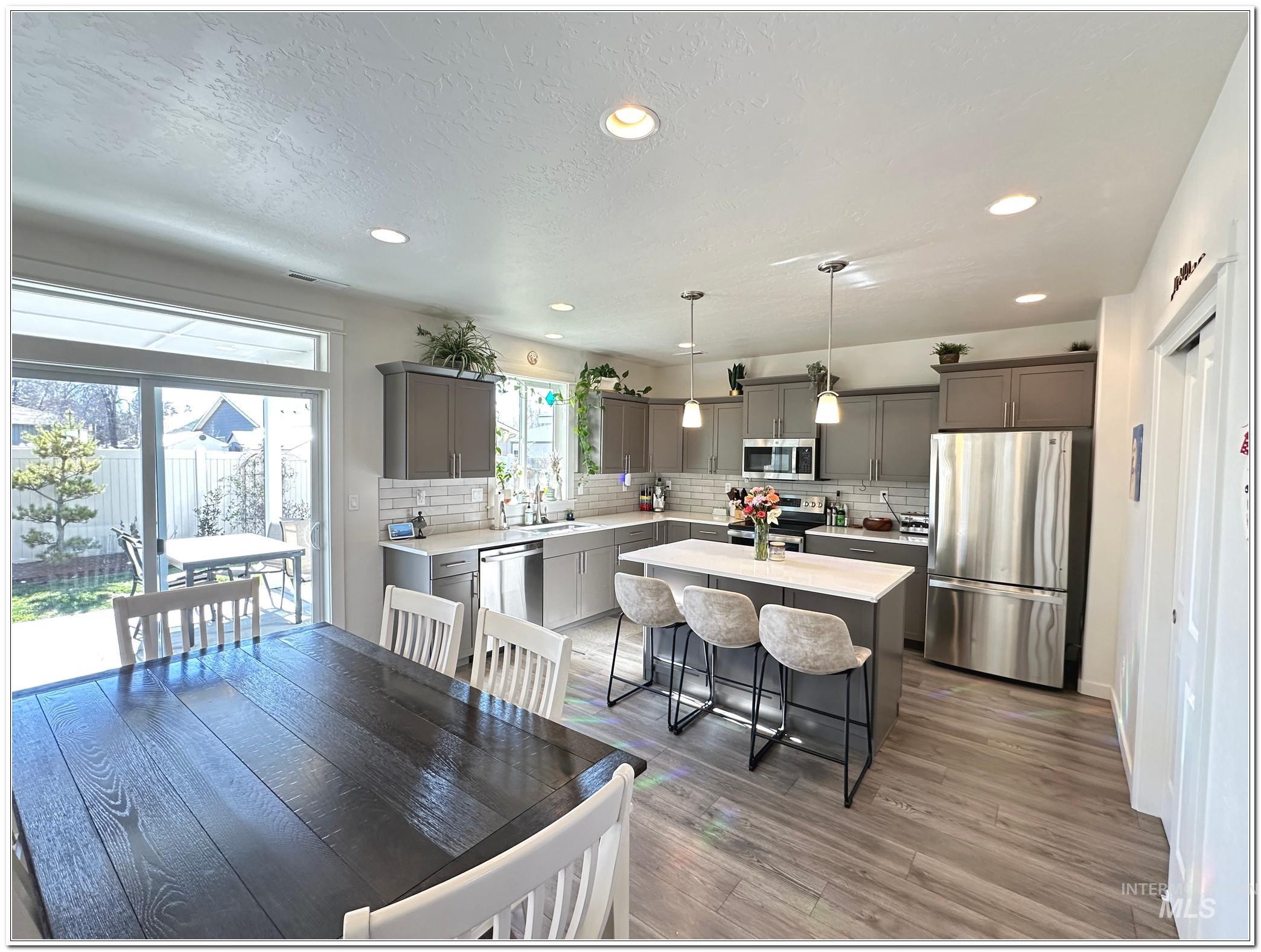 9687 West Arnold Road Boise, ID 83714 - Photo 7 of 49 Dining room featuring recessed lighting, dark wood-type flooring, and a textured ceiling