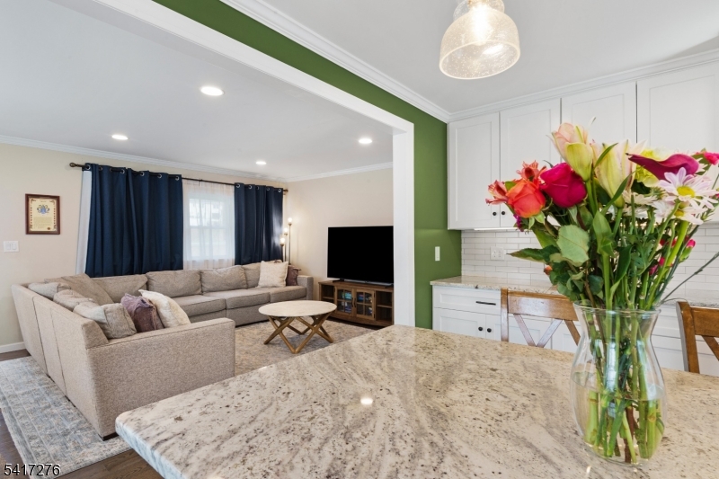 255 Dover Chester Road Randolph, NJ 07869 - Photo 11 of 37 a living room with furniture a flowers and a flat screen tv