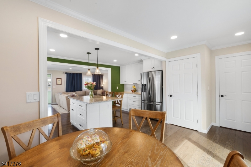 255 Dover Chester Road Randolph, NJ 07869 - Photo 14 of 37 a kitchen with stainless steel appliances kitchen island granite countertop a dining table chairs and a refrigerator