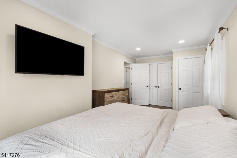 255 Dover Chester Road Randolph, NJ 07869 - Photo 16 of 37 a bedroom with a bed and a flat screen tv