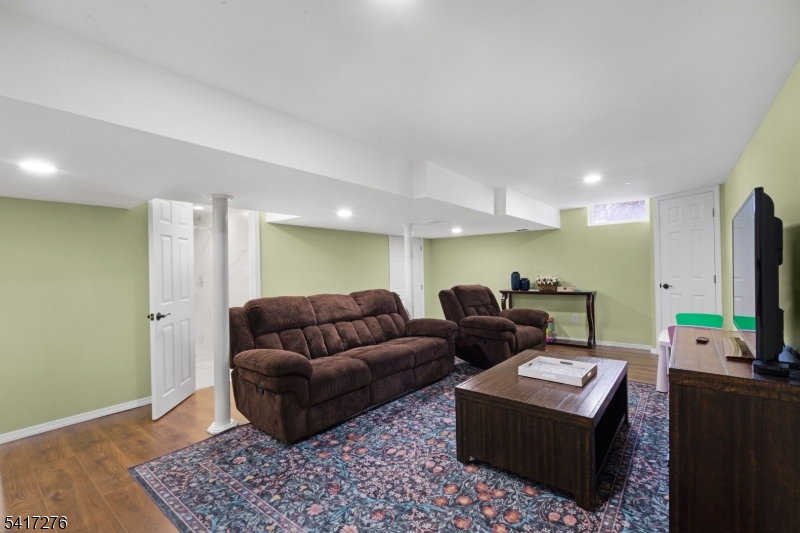 255 Dover Chester Road Randolph, NJ 07869 - Photo 19 of 37 a living room with furniture and a flat screen tv