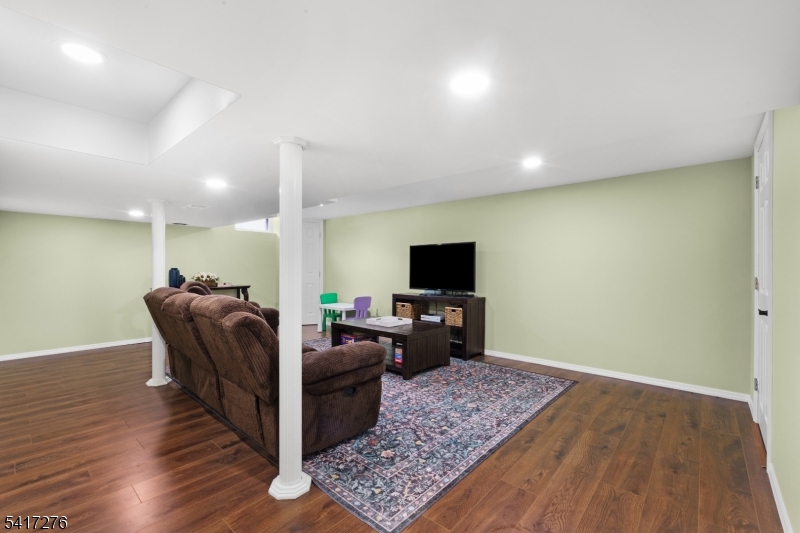 255 Dover Chester Road Randolph, NJ 07869 - Photo 20 of 37 a living room with furniture and a flat screen tv