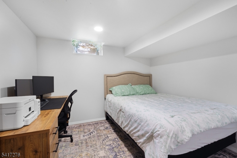 255 Dover Chester Road Randolph, NJ 07869 - Photo 23 of 37 a bedroom with a bed a desk and chair