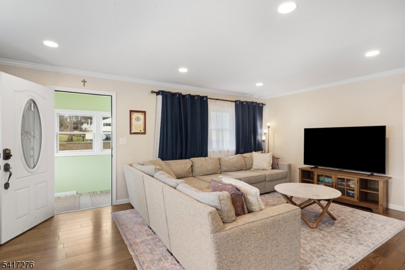 255 Dover Chester Road Randolph, NJ 07869 - Photo 6 of 37 a living room with furniture and a flat screen tv