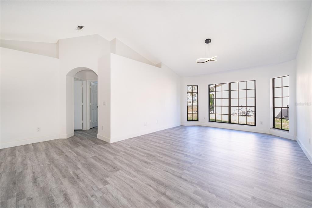 2006 Key Lime Street Ocoee, FL 34761 - Photo 13 of 28 a view of an empty room with wooden floor and a window