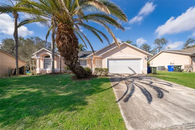 a front view of a house with yard and green space