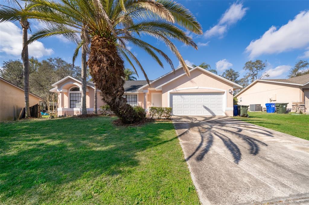 2006 Key Lime Street Ocoee, FL 34761 - Photo 2 of 28 a front view of a house with yard and green space