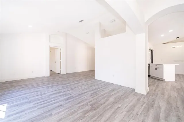 a view of a room with wooden floor