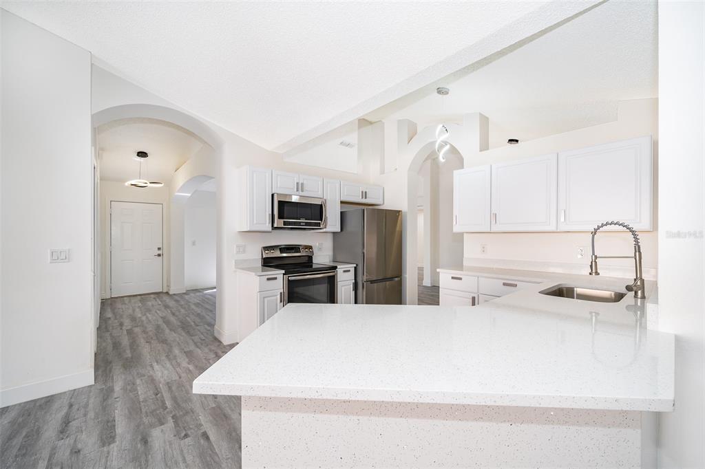 2006 Key Lime Street Ocoee, FL 34761 - Photo 10 of 28 a kitchen with stainless steel appliances a refrigerator sink and microwave
