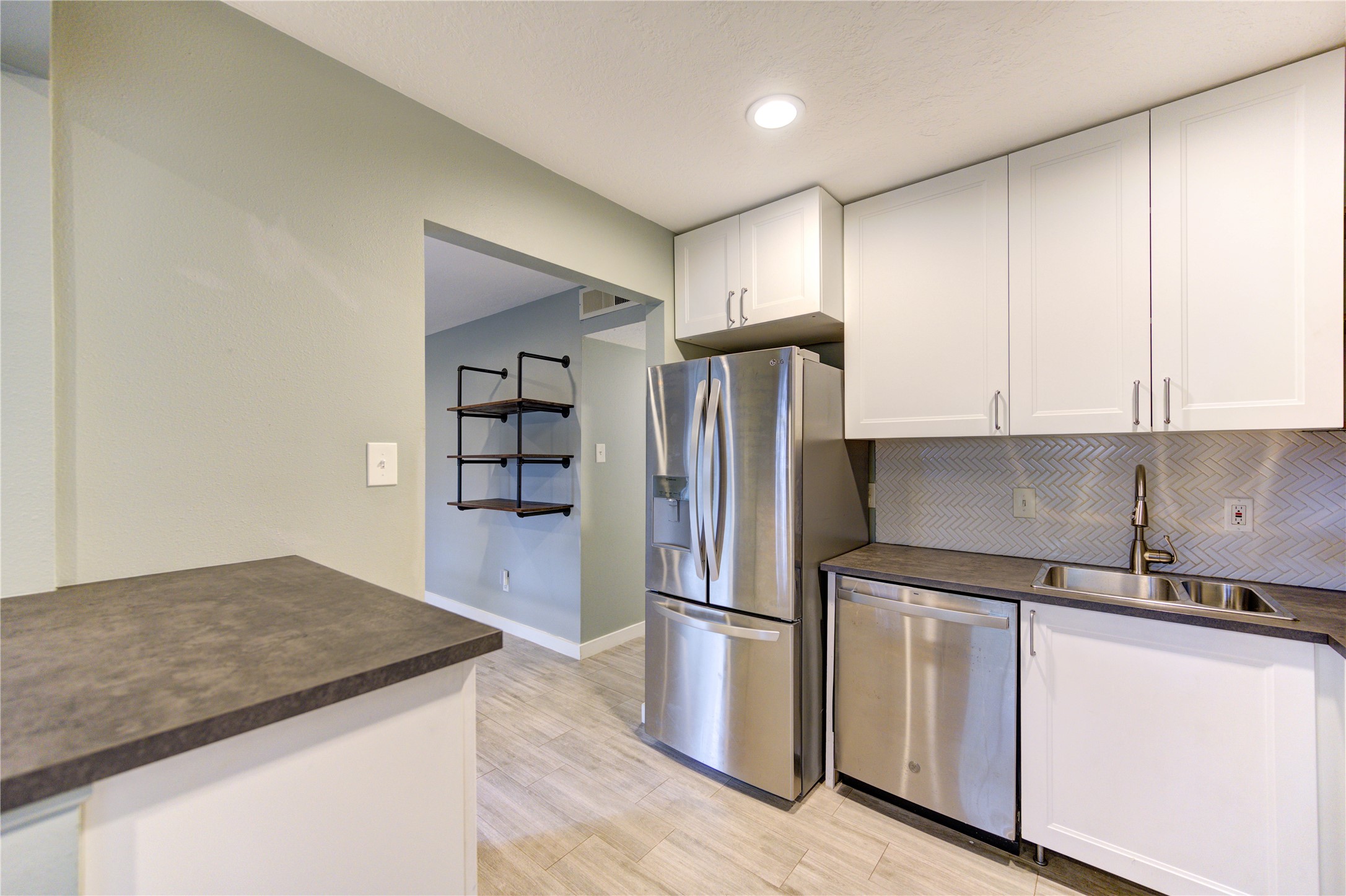 3224 Timmons Lane, Unit 155 Houston, TX 77027 - Photo 16 of 50 a kitchen with stainless steel appliances granite countertop a refrigerator a sink and a stove