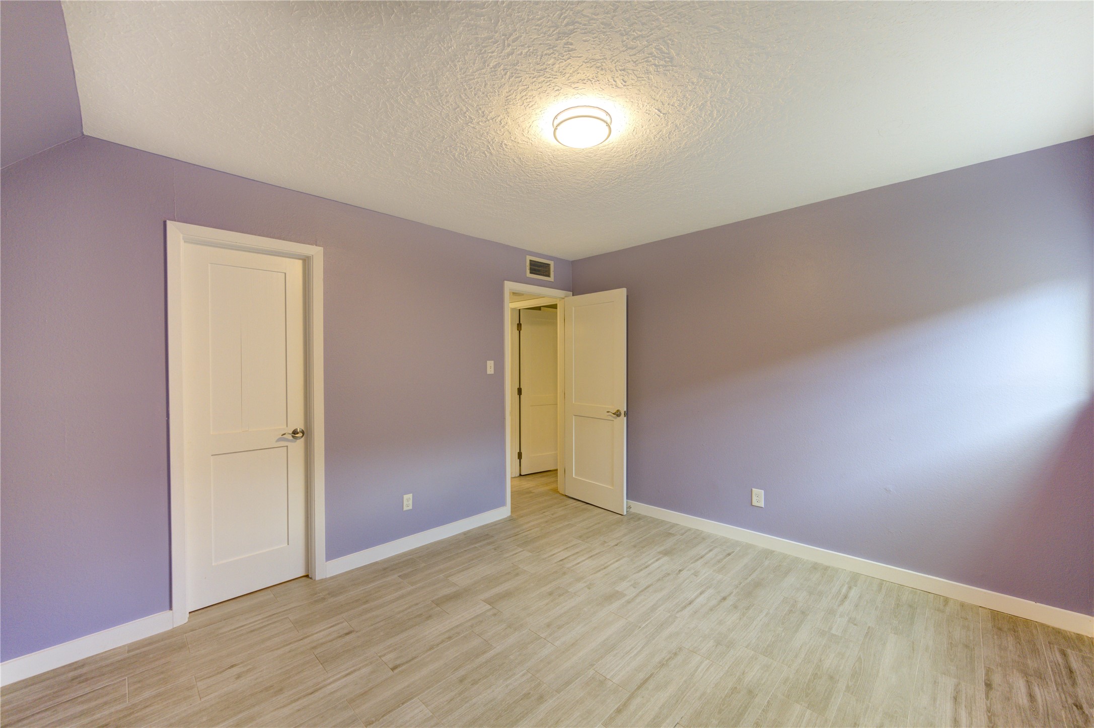 3224 Timmons Lane, Unit 155 Houston, TX 77027 - Photo 20 of 50 an empty room with wooden floor and windows